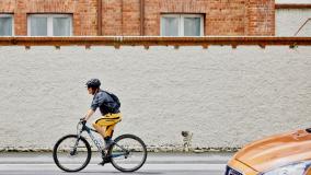 Man cycling right to left across the screen
