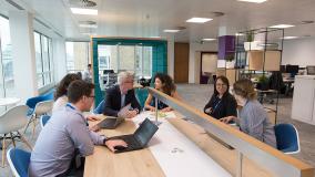 People collaborating around a table in the Jacobs London office