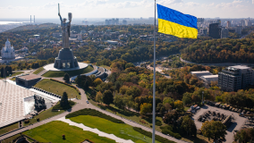 Ukraine flag flying over the city in the background