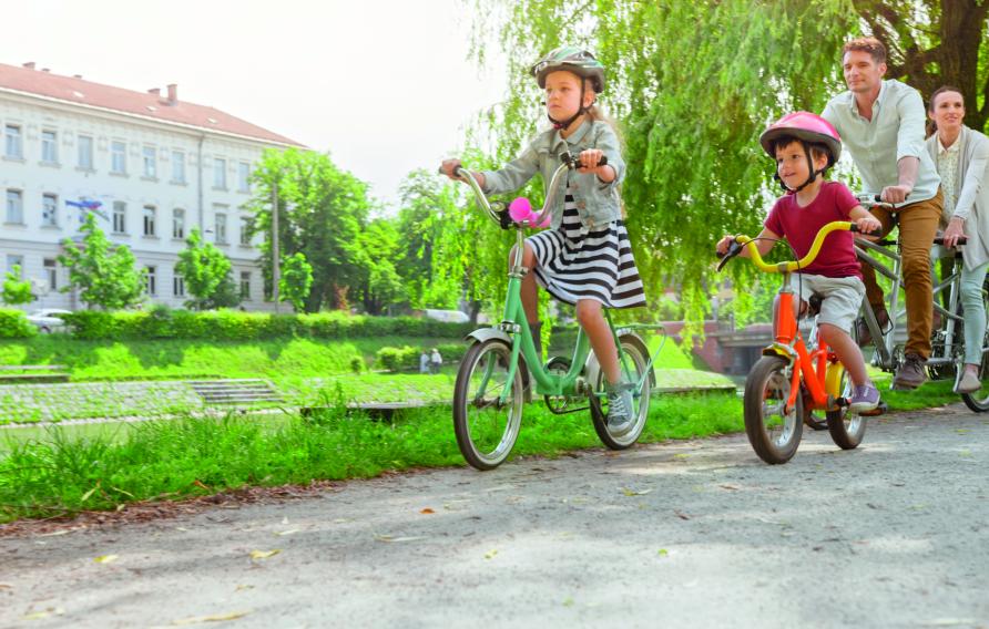 Family of 4 riding bikes