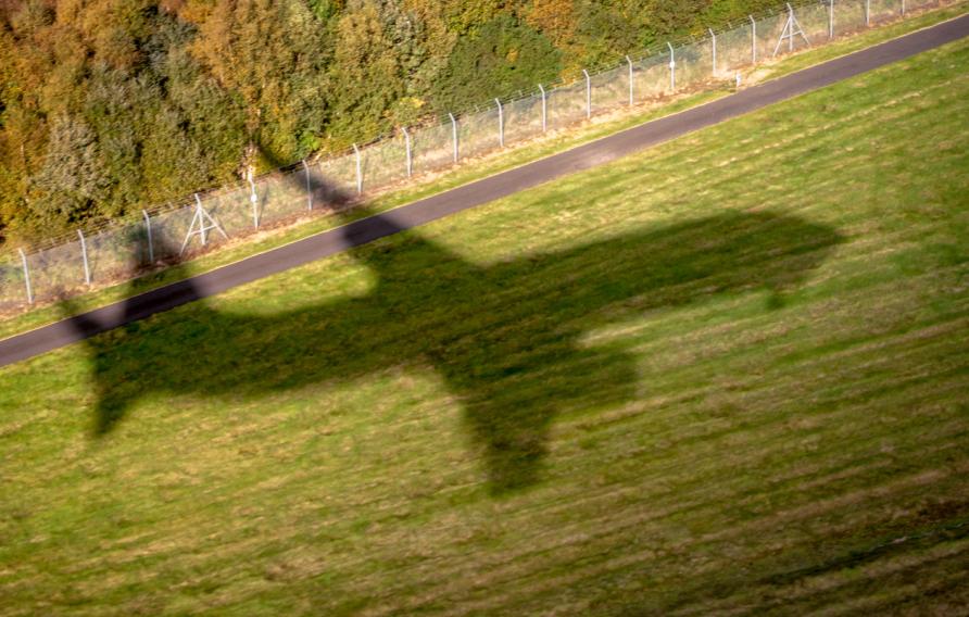 The shadow of a commercial jet as it comes in to land at Edinburgh Airport, Scotland.