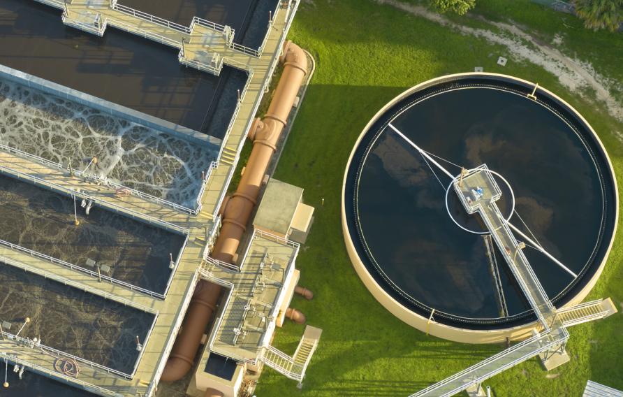 Aerial view of modern water cleaning facility at urban wastewater treatment plant. Purification process of removing undesirable chemicals, suspended solids and gases from contaminated liquid stock photo