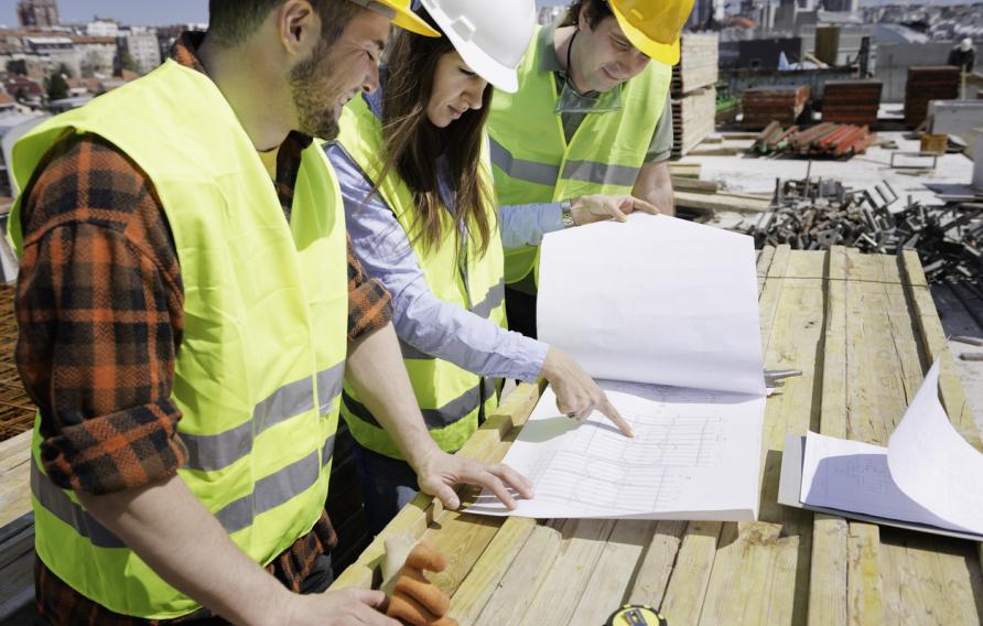 Architect having a meeting with construction team on site