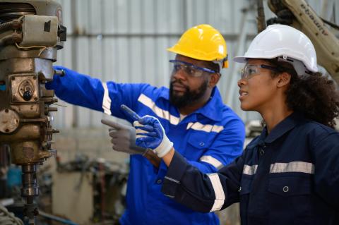 Both of engineers are consulting and exchanging repair experience with each other. about repairing old machines to return to normal operation.