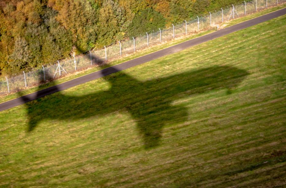 The shadow of a commercial jet as it comes in to land at Edinburgh Airport, Scotland.