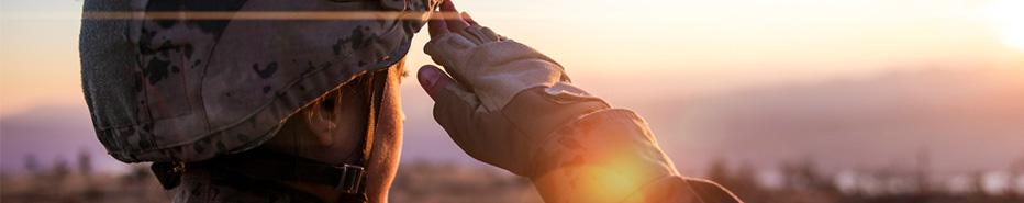 Female Army Solider Saluting against sunset sky