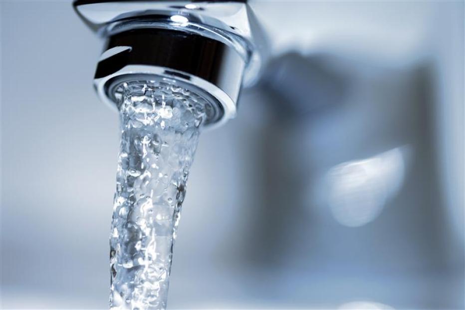 Faucet close-up with running water.