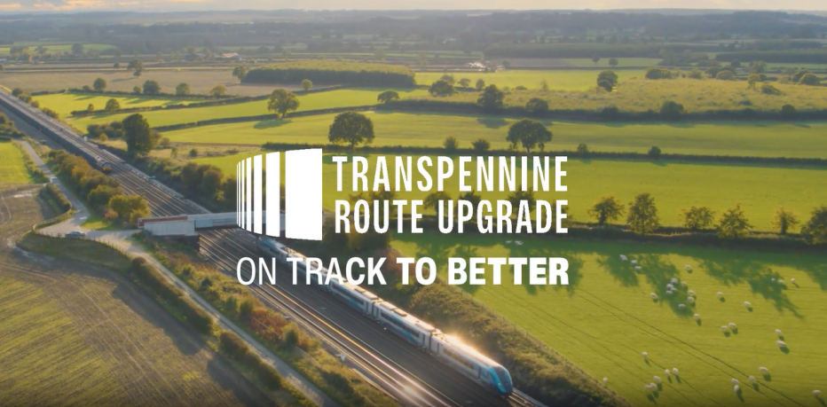 Train running through countryside with title Transpennine Route Upgrade "On Track to Better"