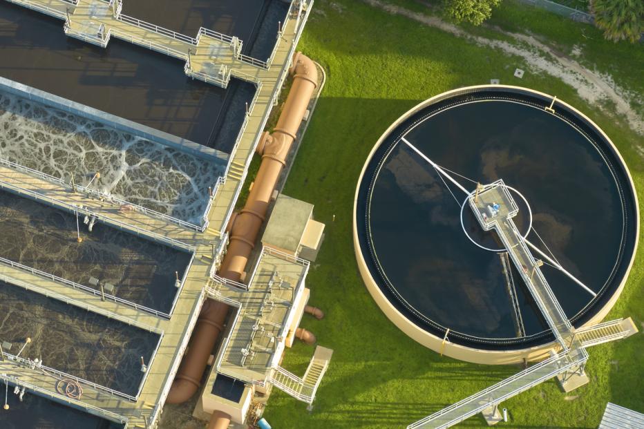 Aerial view of modern water cleaning facility at urban wastewater treatment plant. Purification process of removing undesirable chemicals, suspended solids and gases from contaminated liquid.